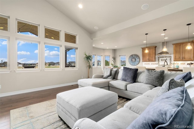 5954 Black Lion Ct, Windsor, CO 80550 - living area with dark wood-style flooring, recessed lighting, baseboards, and high vaulted ceiling