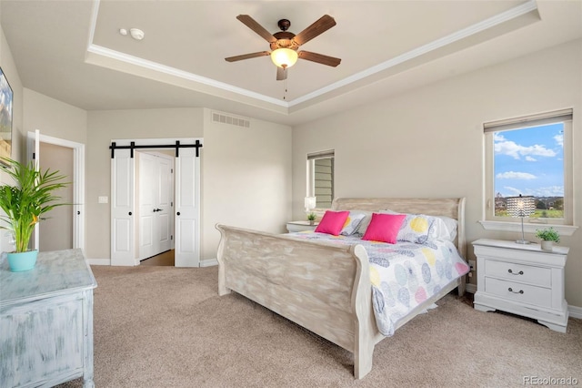 5954 Black Lion Ct, Windsor, CO 80550 - bedroom featuring a raised ceiling, carpet floors, a barn door, baseboards, and crown molding