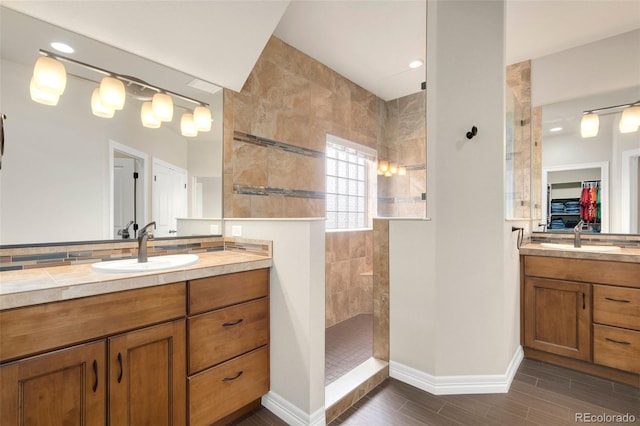 5954 Black Lion Ct, Windsor, CO 80550 - bathroom with a walk in shower, wood finished floors, two vanities, baseboards, and recessed lighting