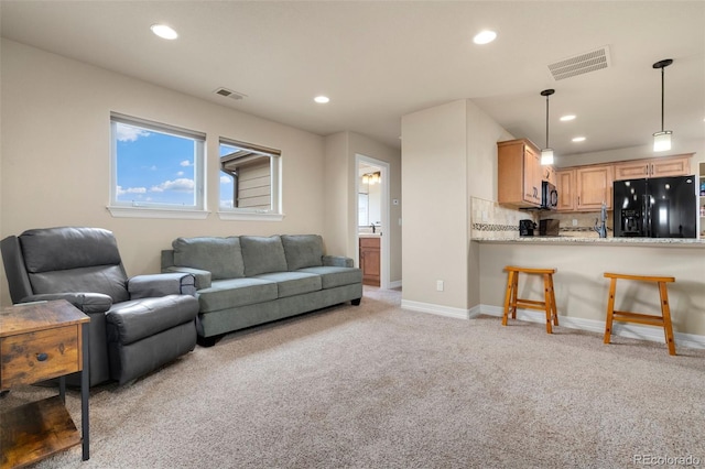 5954 Black Lion Ct, Windsor, CO 80550 - living room featuring light colored carpet, recessed lighting, and baseboards