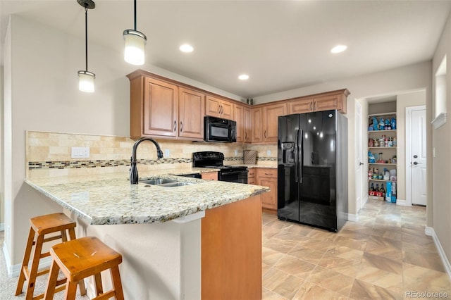 5954 Black Lion Ct, Windsor, CO 80550 - kitchen with black appliances, a sink, a peninsula, light stone counters, and recessed lighting