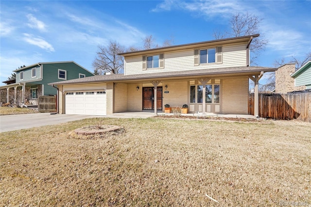 traditional-style house featuring brick siding, driveway, an attached garage, and fence