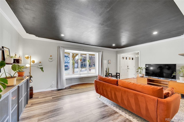 living room with baseboards, a textured ceiling, crown molding, and light wood-style floors