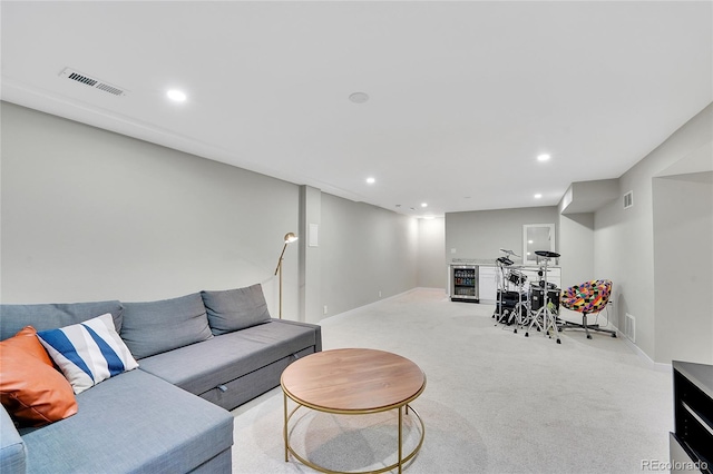 living room with visible vents, baseboards, wine cooler, light colored carpet, and recessed lighting