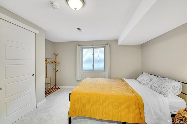 carpeted bedroom with visible vents and baseboards