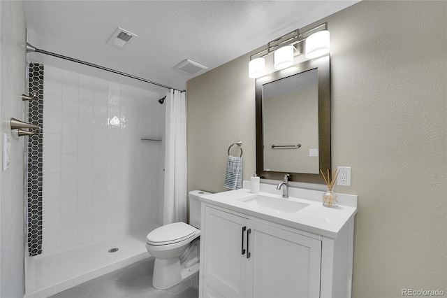 bathroom with toilet, visible vents, and a tile shower