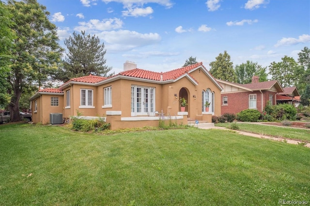 1295 S Downing St, Denver, CO 80210 - mediterranean / spanish house featuring a chimney, stucco siding, a front yard, and a tiled roof