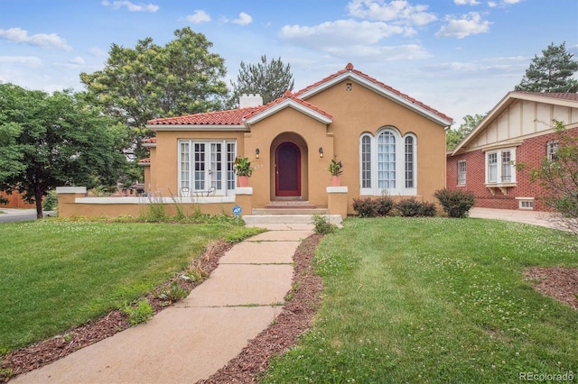 1295 S Downing St, Denver, CO 80210 - mediterranean / spanish home featuring stucco siding, a tiled roof, a front lawn, and a chimney
