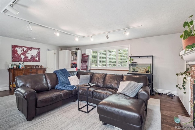 1295 S Downing St, Denver, CO 80210 - living room featuring rail lighting, wood finished floors, and a textured ceiling