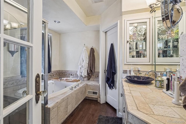 1295 S Downing St, Denver, CO 80210 - bathroom featuring a jetted tub, wood finished floors, and vanity