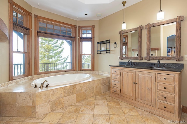 full bath featuring a sink, plenty of natural light, and a bath