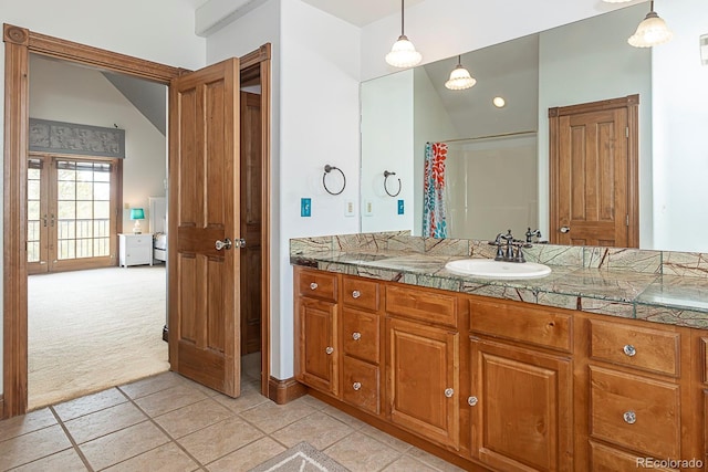 bathroom with tile patterned flooring, curtained shower, and vanity