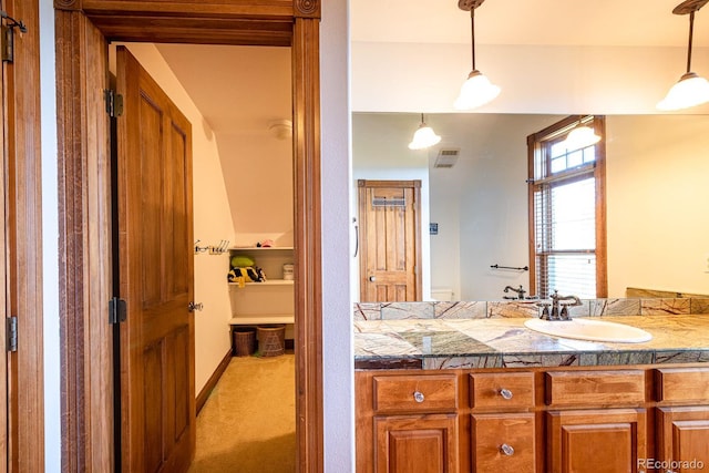 bathroom with vanity, baseboards, and visible vents