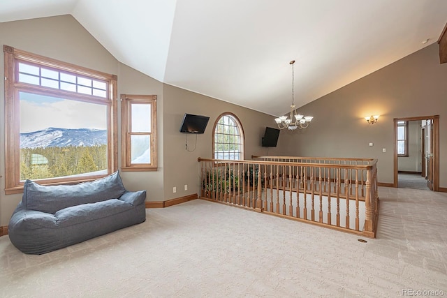 living area featuring high vaulted ceiling, a notable chandelier, baseboards, and light carpet