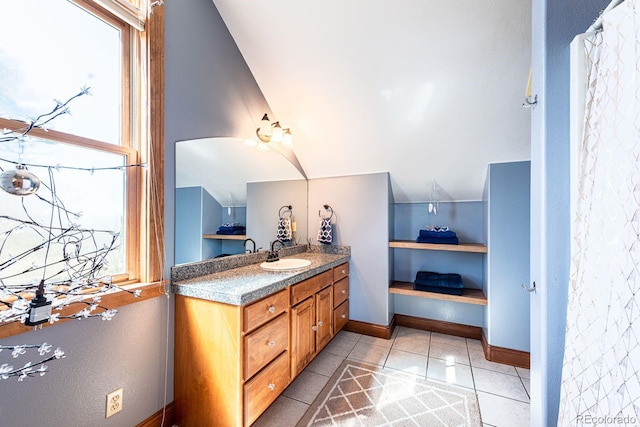 bathroom with tile patterned floors, baseboards, and vanity