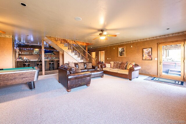 living area featuring stairway, carpet floors, ceiling fan, pool table, and a dry bar