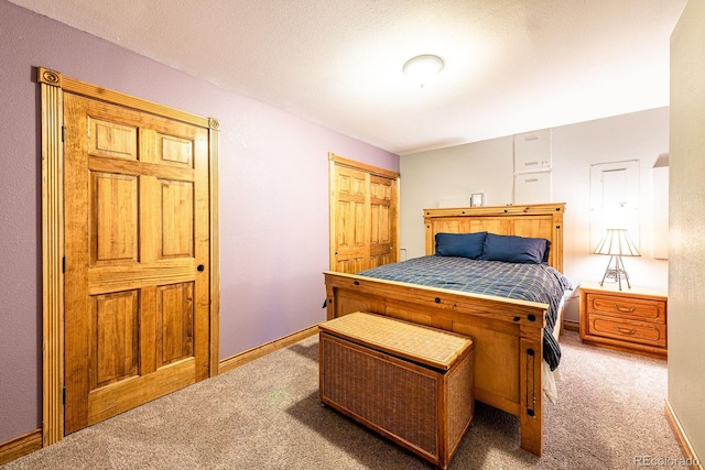 bedroom with carpet flooring and baseboards