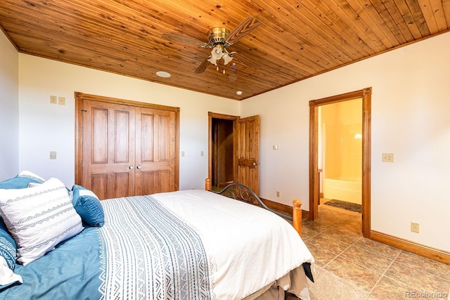 bedroom with baseboards, wood ceiling, light tile patterned floors, a closet, and a ceiling fan