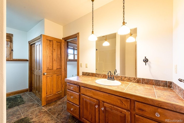 bathroom with vanity and baseboards