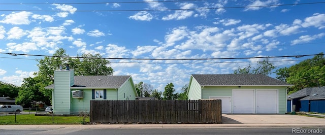 1391 Elmira St, Aurora, CO 80010 - view of front of property with a chimney, an outbuilding, and a garage