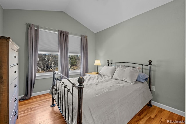 bedroom featuring lofted ceiling and wood-type flooring