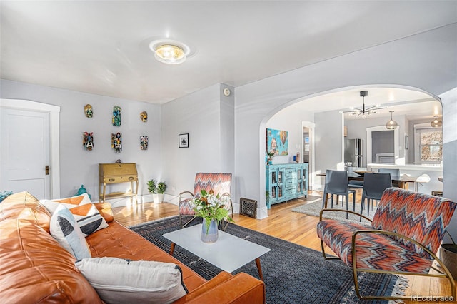 living room with an inviting chandelier and light hardwood / wood-style floors