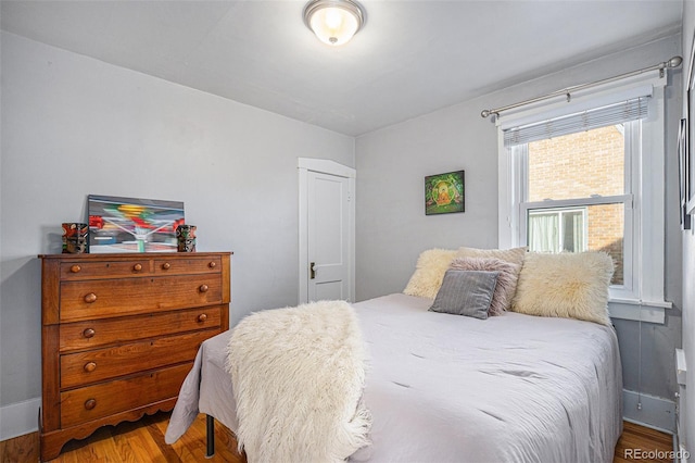 bedroom with hardwood / wood-style flooring