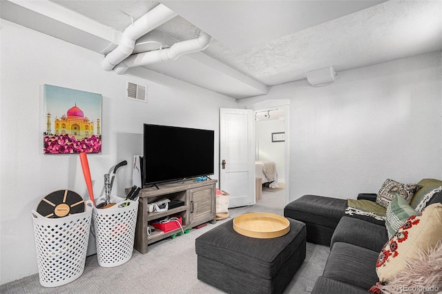 carpeted living room featuring a textured ceiling