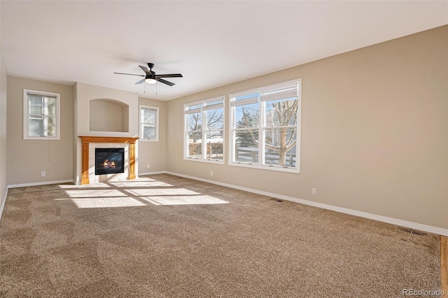 unfurnished living room with carpet flooring and ceiling fan