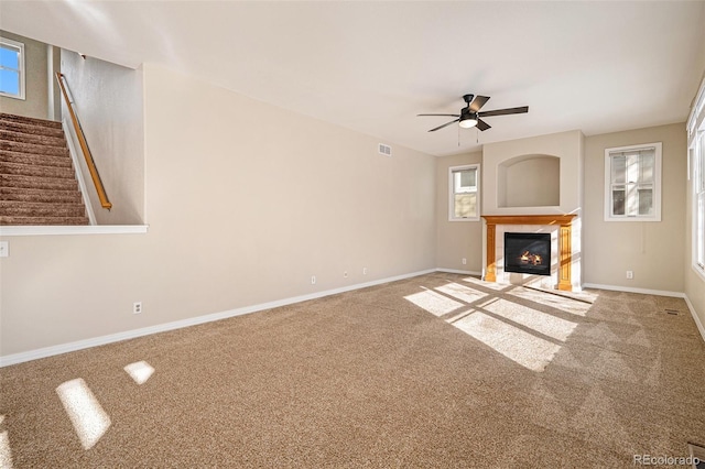 unfurnished living room with ceiling fan and carpet floors