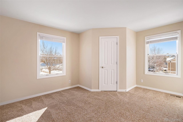 spare room with carpet flooring and a healthy amount of sunlight