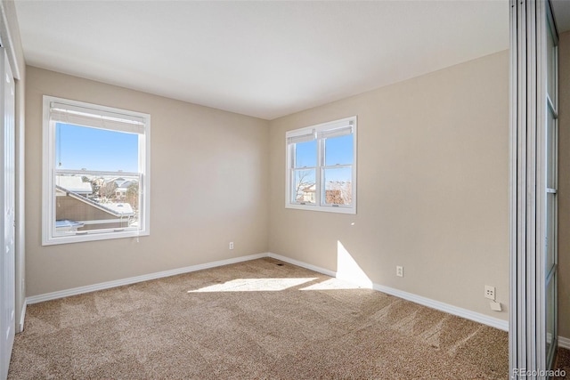 unfurnished room featuring light carpet