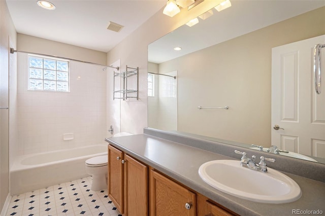 full bathroom with vanity, toilet, and tiled shower / bath