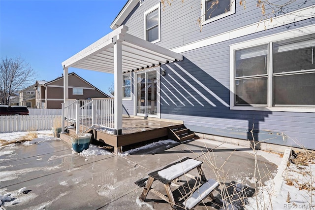 snow covered patio featuring a deck