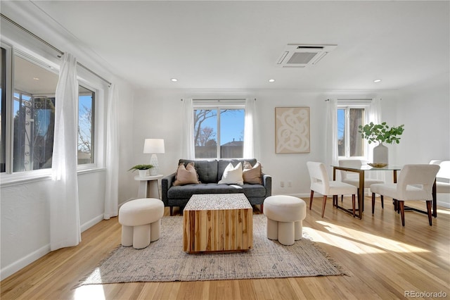 living area featuring light wood-type flooring and baseboards