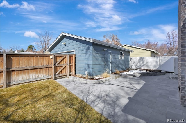 view of outbuilding with a gate and fence