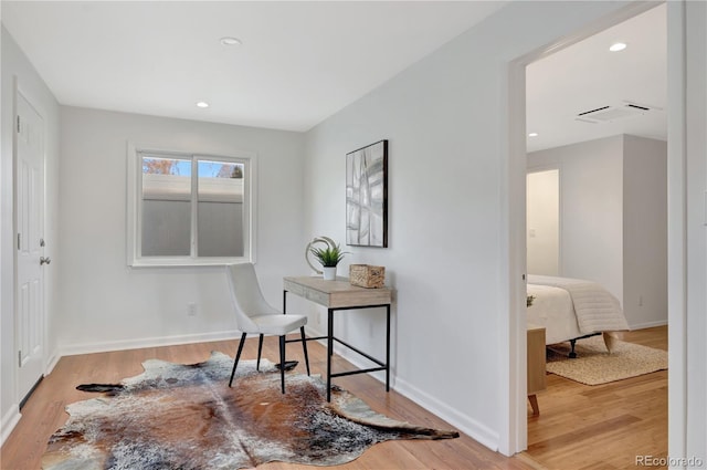 office with light wood finished floors, visible vents, baseboards, and recessed lighting