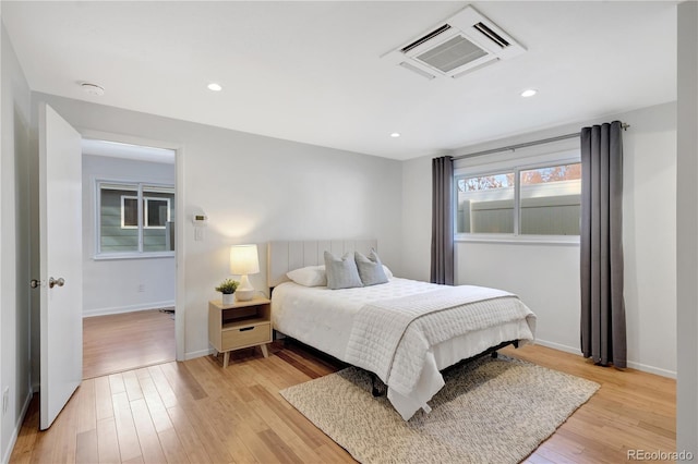 bedroom featuring light wood-type flooring, baseboards, and recessed lighting