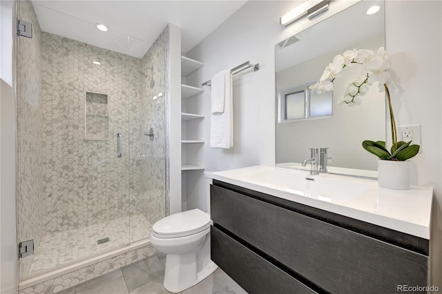 full bathroom featuring vanity, a shower stall, and toilet