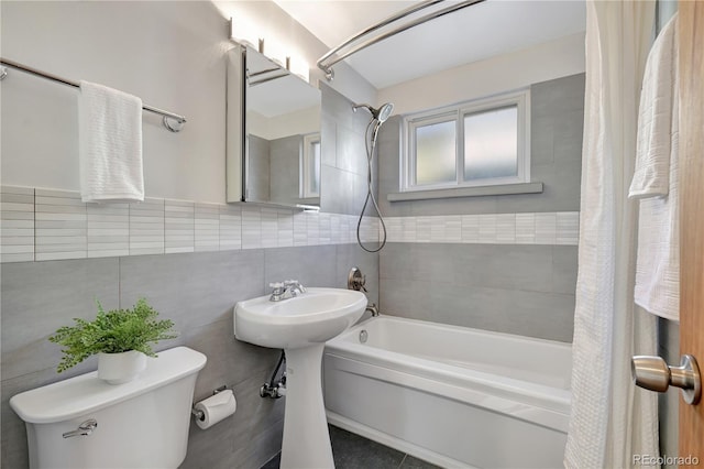 full bathroom with shower / bath combination with curtain, tile walls, and toilet