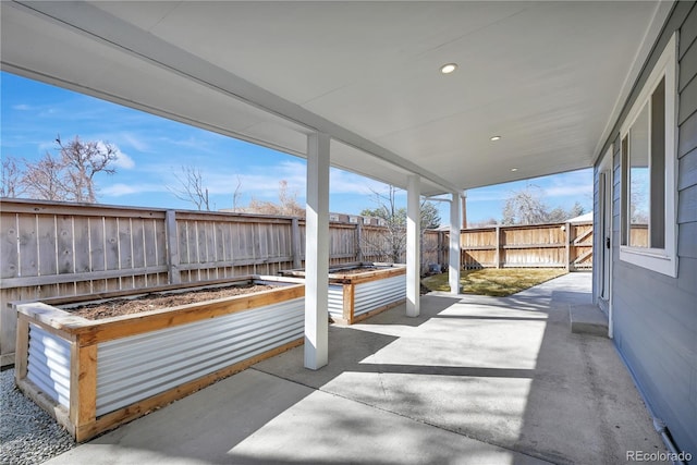 view of patio / terrace featuring a fenced backyard and a vegetable garden