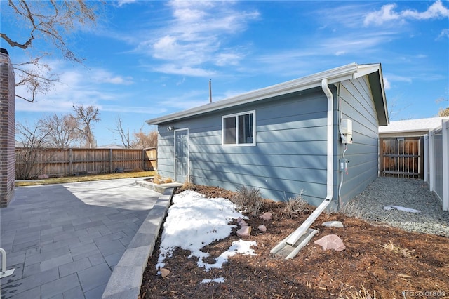 view of side of property with a patio area and a fenced backyard