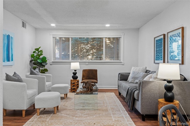 7615 E Quincy Ave Unit 103, Denver, CO 80237 - living room with a textured ceiling, wood finished floors, and recessed lighting