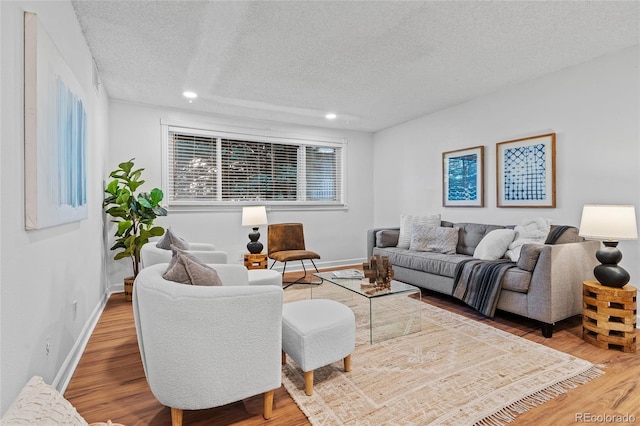 7615 E Quincy Ave Unit 103, Denver, CO 80237 - living area featuring a textured ceiling, wood finished floors, and recessed lighting