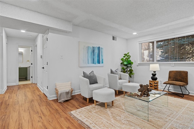 7615 E Quincy Ave Unit 103, Denver, CO 80237 - living area featuring light wood-type flooring, a textured ceiling, and recessed lighting