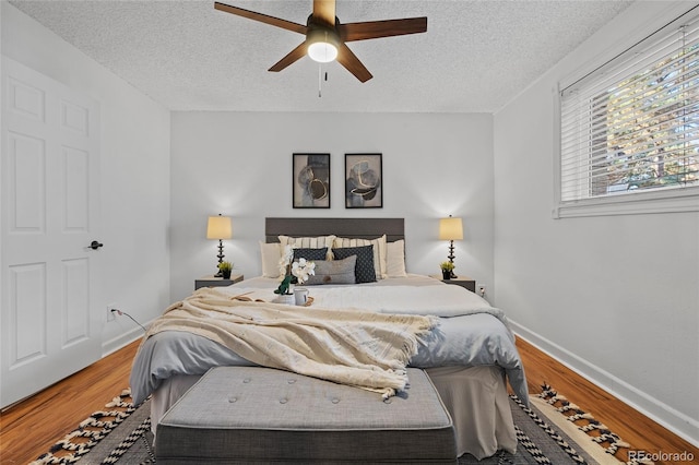 7615 E Quincy Ave Unit 103, Denver, CO 80237 - bedroom featuring a textured ceiling, wood finished floors, and ceiling fan