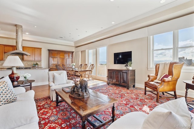 living room featuring crown molding, plenty of natural light, and recessed lighting