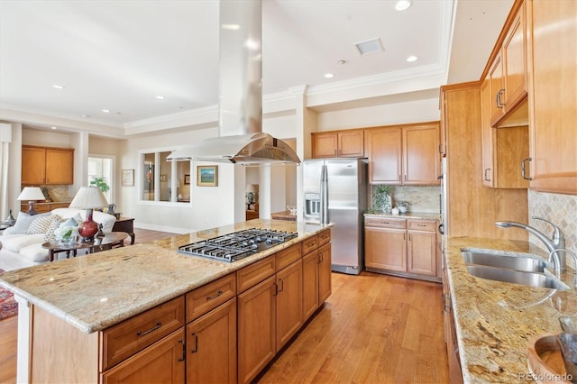 kitchen with light wood-style flooring, a sink, stainless steel appliances, island range hood, and light stone counters