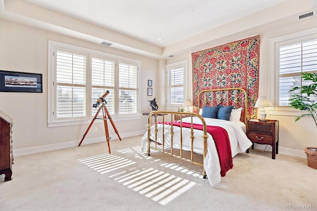 carpeted bedroom featuring baseboards and visible vents