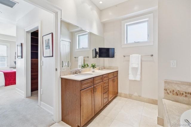 full bathroom featuring baseboards, visible vents, a sink, and double vanity